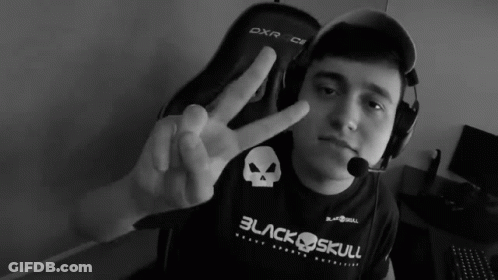 A Man Wearing A Black Shirt That Says Black Skull Giving A Peace Sign GIF