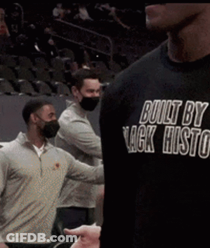 A Man Wearing A Black Shirt That Says Built By Lack Histo GIF
