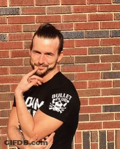 A Man Wearing A Black Shirt That Says Bullet Club GIF
