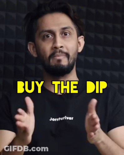 A Man Wearing A Black Shirt That Says Buy The Dip On It GIF