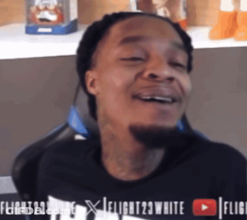 A Man Wearing A Black Shirt That Says Flight 23 White GIF