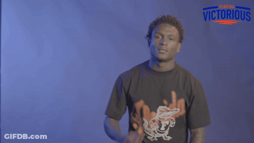 A Man Wearing A Black Shirt That Says Florida Victorious On It GIF