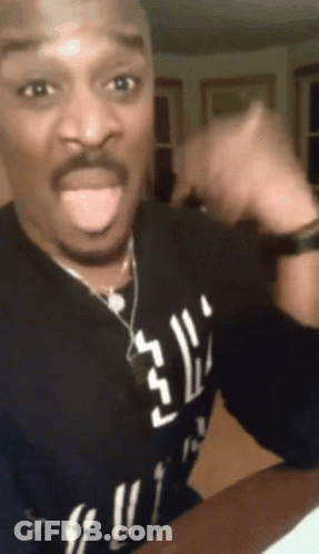 A Man Wearing A Black Shirt That Says ' Gucci ' On It Is Sticking His Tongue Out GIF