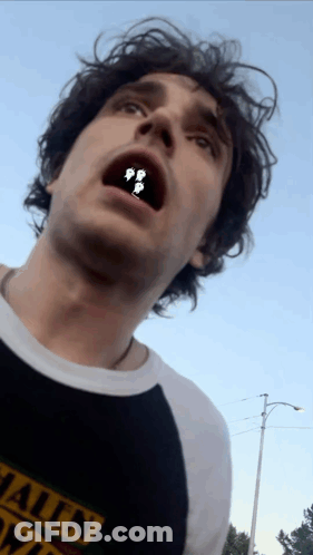 A Man Wearing A Black Shirt That Says ' Hawaii ' On It GIF