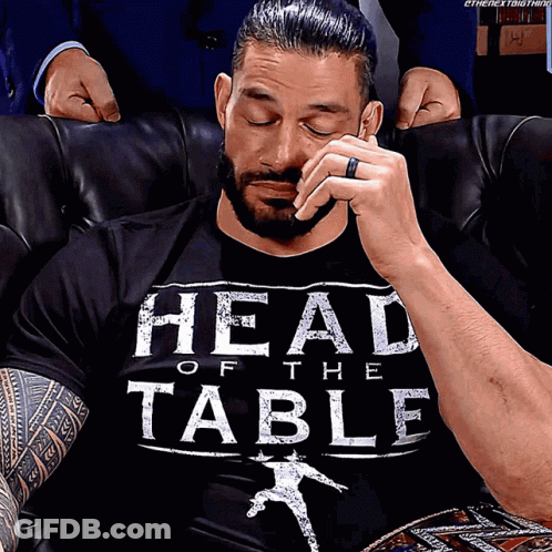 A Man Wearing A Black Shirt That Says Head Of The Table On It GIF