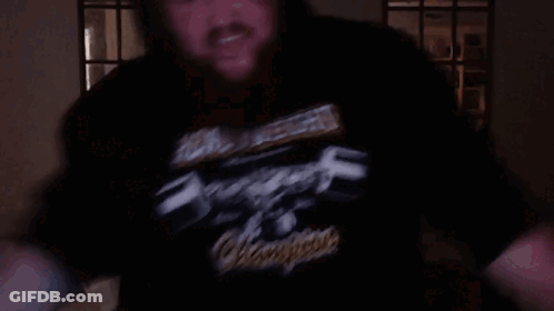 A Man Wearing A Black Shirt That Says Heavy Metal GIF