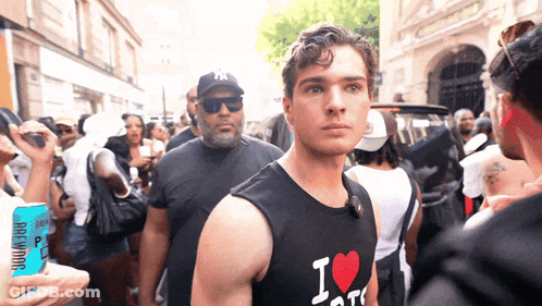 A Man Wearing A Black Shirt That Says I Love Ny GIF