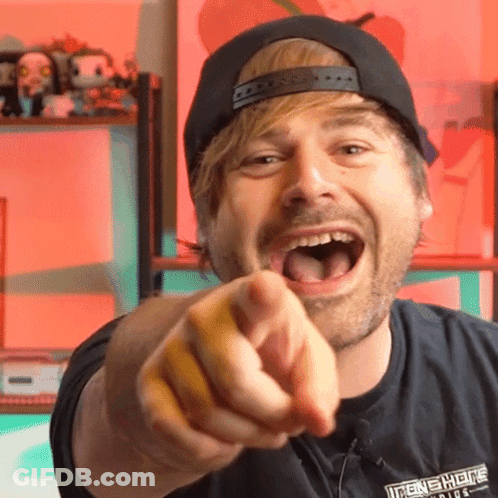 A Man Wearing A Black Shirt That Says Iron Shields Is Pointing His Finger GIF