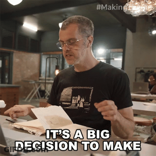 A Man Wearing A Black Shirt That Says " It 'S A Big Decision To Make " On It GIF