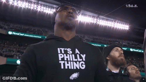A Man Wearing A Black Shirt That Says " It 'S A Philly Thing " GIF