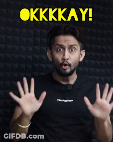 A Man Wearing A Black Shirt That Says Jerryparivar Shows His Hands In Front Of A Sign That Says Okkkay GIF