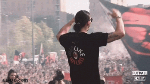 A Man Wearing A Black Shirt That Says Like Milan GIF