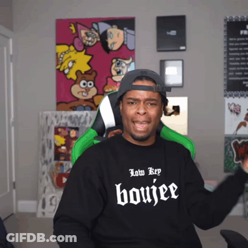 A Man Wearing A Black Shirt That Says Low Key Boujee On It GIF
