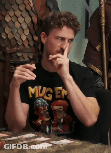 A Man Wearing A Black Shirt That Says Mugen Covering His Mouth GIF