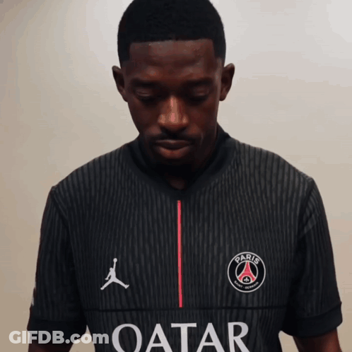 A Man Wearing A Black Shirt That Says Qatar GIF
