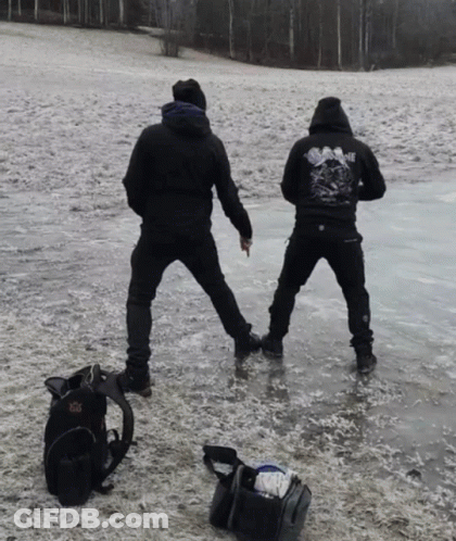 A Man Wearing A Black Shirt That Says Sunshine Is Standing On A Frozen Lake GIF