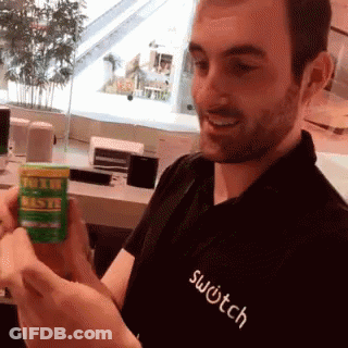 A Man Wearing A Black Shirt That Says Switch Holds A Green Bottle GIF