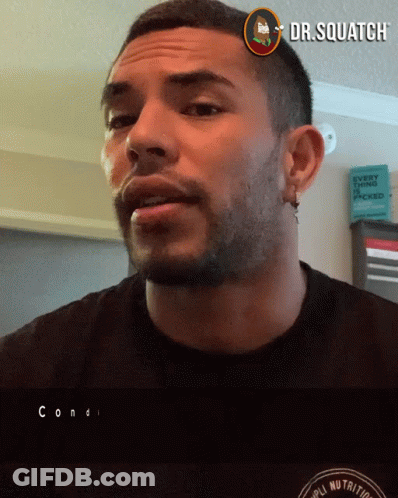 A Man Wearing A Black Shirt With A Dr.squatch Logo Above His Head GIF