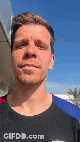 A Man Wearing A Black Shirt With A Fcb Logo On The Front Looks At The Camera GIF