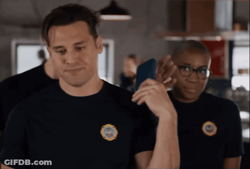 A Man Wearing A Black Shirt With A Fire Department Patch On It GIF