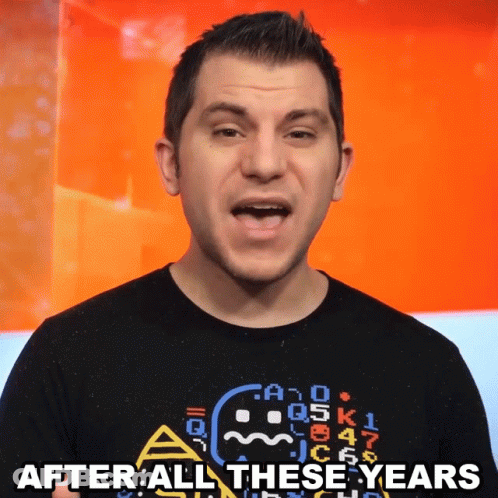 A Man Wearing A Black Shirt With A Ghost On It Says After All These Years GIF