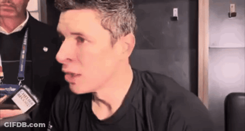 A Man Wearing A Black Shirt With A Lanyard Around His Neck That Says Canadian Airlines On It GIF