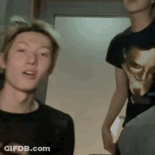 A Man Wearing A Black Shirt With A Picture Of A Man On It GIF