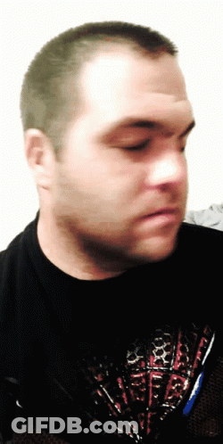 A Man Wearing A Black Shirt With A Red White And Blue Design GIF