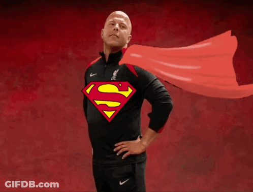 A Man Wearing A Black Shirt With A Superman Logo On The Front GIF