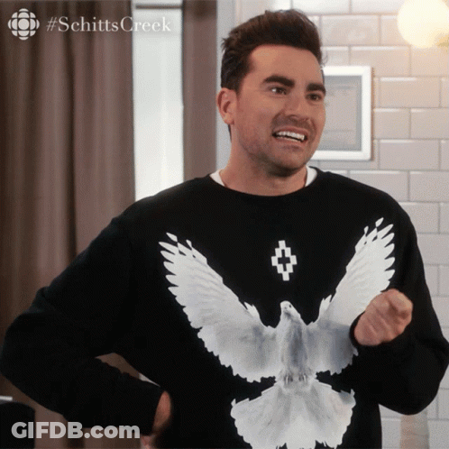 A Man Wearing A Black Shirt With A White Bird On It GIF