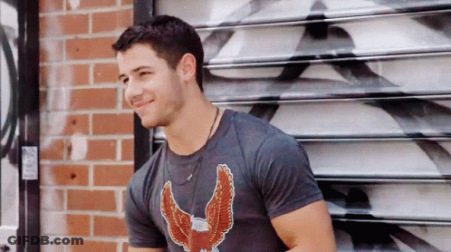 A Man Wearing A Black Shirt With An Eagle On It GIF