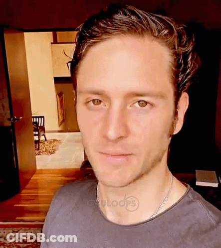 A Man Wearing A Black Shirt With Cvuloops Written On The Collar GIF