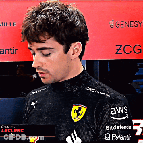 A Man Wearing A Black Shirt With Ferrari On It GIF