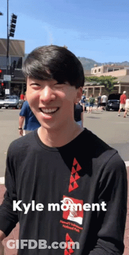 A Man Wearing A Black Shirt With Kyle Moment Written On It GIF