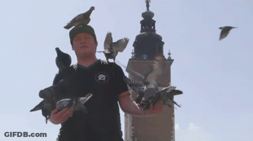 A Man Wearing A Black Shirt With The Letter A On It GIF