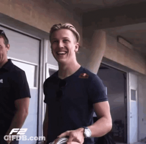 A Man Wearing A Black Shirt With The Letter F2 On The Front GIF