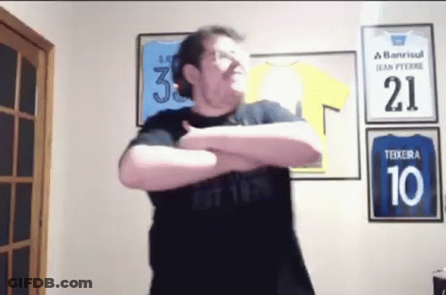 A Man Wearing A Black Shirt With The Number 10 On It Is Standing In Front Of A Wall With Jerseys On It . GIF