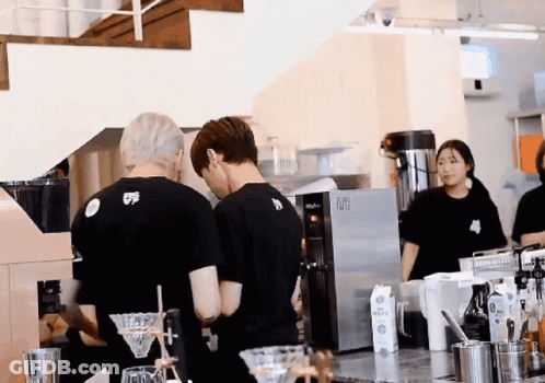 A Man Wearing A Black Shirt With The Number 5 On It Is Standing In A Kitchen GIF