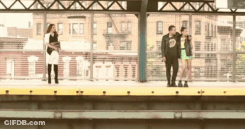 A Man Wearing A Black Shirt With The Number 9 On It Stands Next To Two Women GIF