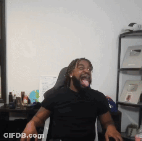 A Man Wearing A Black Shirt With The Word La On It Sticks His Tongue Out GIF