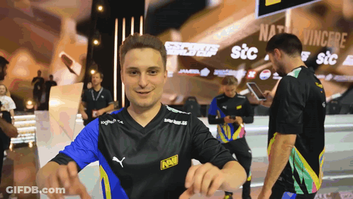 A Man Wearing A Black Shirt With The Word Navi On The Front GIF