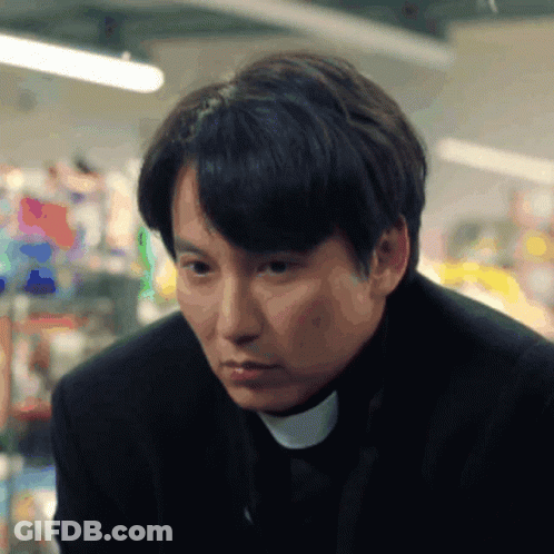 A Man Wearing A Black Suit And A White Collar GIF