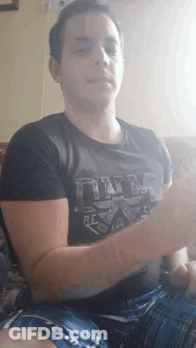 A Man Wearing A Black T-Shirt That Says Dna GIF