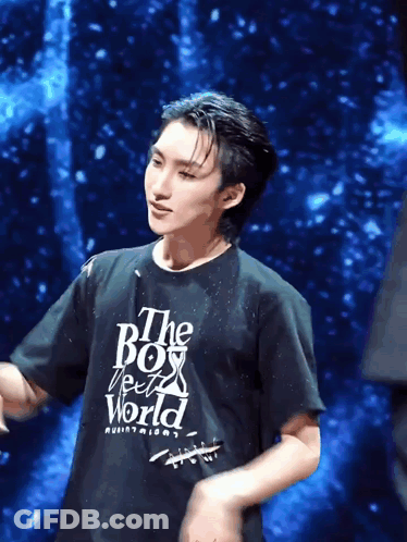 A Man Wearing A Black T-Shirt That Says " The Boy From The World " GIF