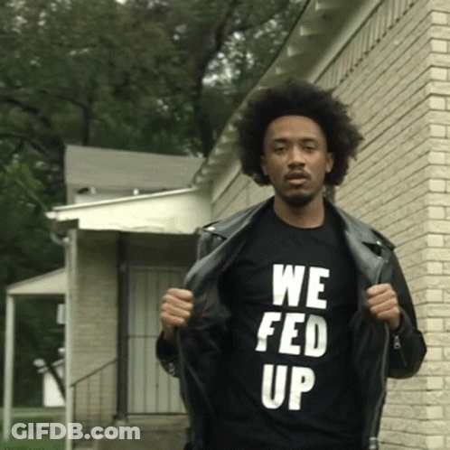 A Man Wearing A Black T-Shirt That Says We Fed Up GIF