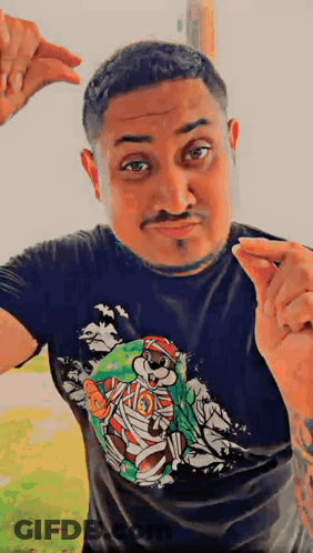 A Man Wearing A Black T-Shirt With A Picture Of A Mummy Bear On It GIF