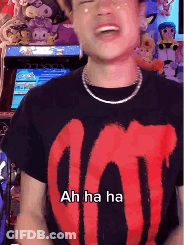 A Man Wearing A Black T-Shirt With A Red Letter O On It Says Ah Ha Ha GIF