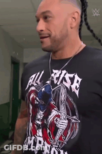 A Man Wearing A Black T-Shirt With A Skeleton On It . GIF