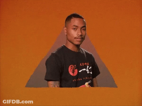 A Man Wearing A Black T-Shirt With Chinese Writing On It Is Standing In Front Of An Orange Background . GIF