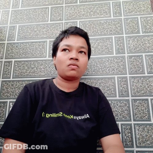 A Man Wearing A Black T-Shirt With The Letters Gnilm2 On It GIF